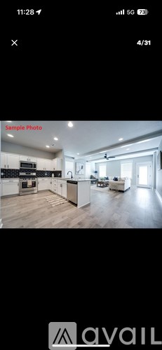 A modern kitchen with a dining area in the background.