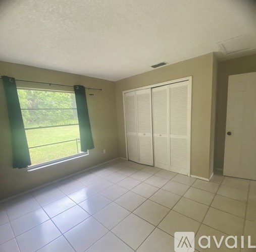 A room with a sliding glass door and a white door.