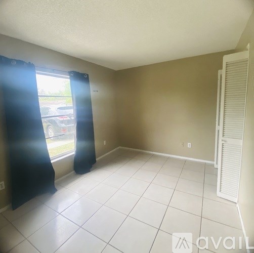 A room with a window and a closed door.