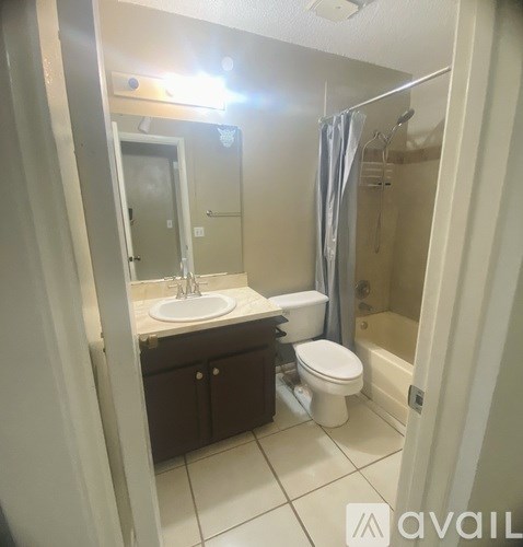 A bathroom with a sink, toilet, and bathtub.