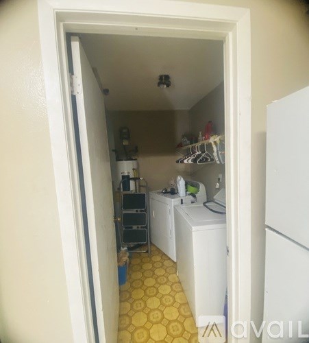 A small laundry room with a washer and dryer.