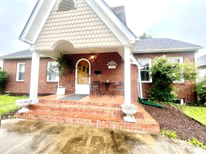 A house with a red brick exterior and a white roof.