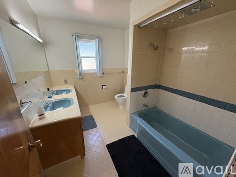 A bathroom with a bathtub, toilet, and sink.