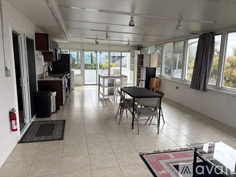 A living room with a dining table and chairs.