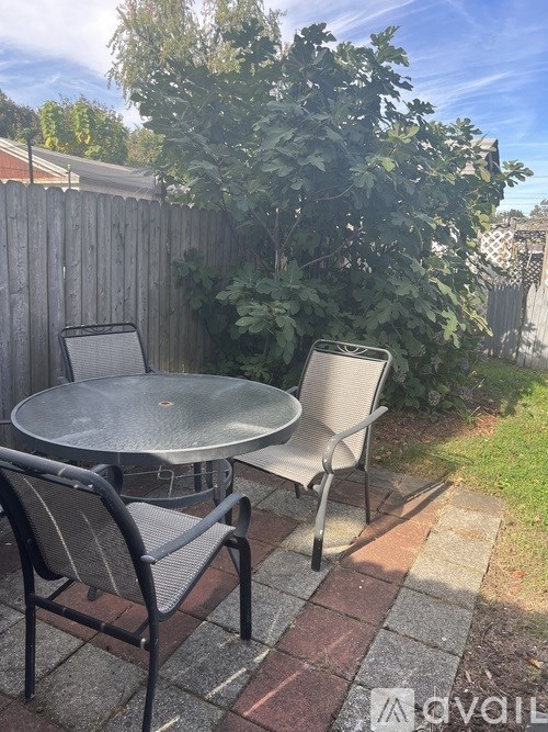 A patio with a table and two chairs.