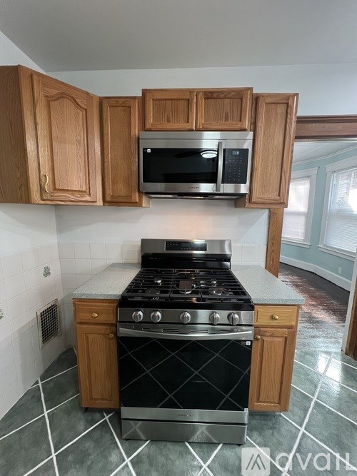 A kitchen with a stove top oven and microwave above it.