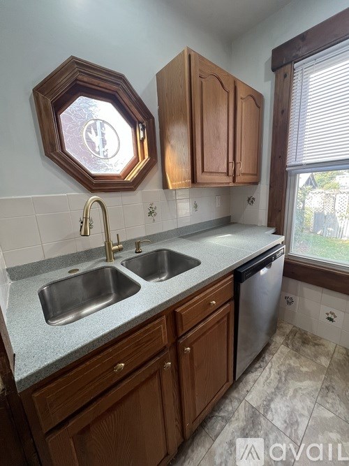 A kitchen with a hexagonal mirror above the sink.