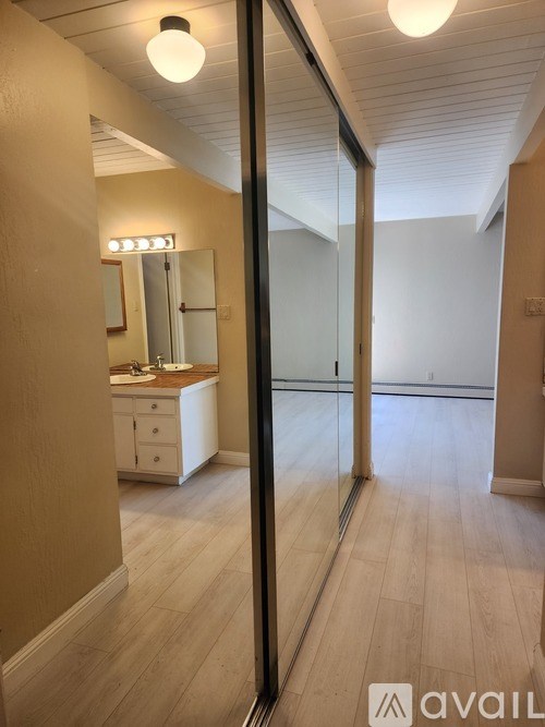 A bathroom with a vanity and a mirror.