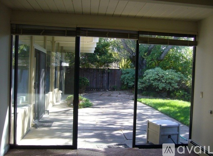 A view from inside a house looking out through a sliding glass door.