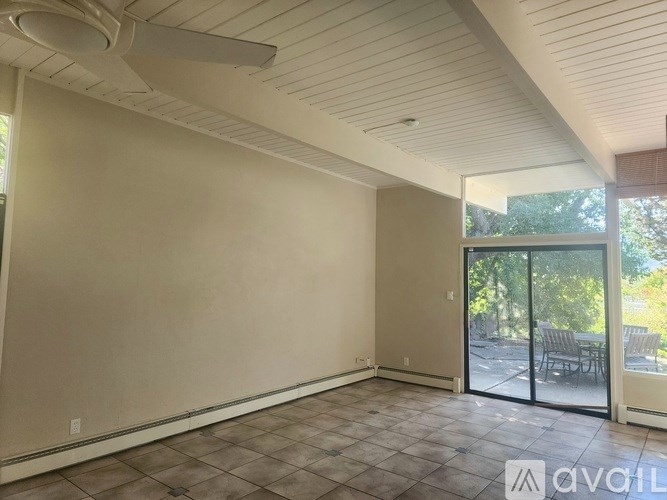 A room with a sliding glass door leading to a patio.