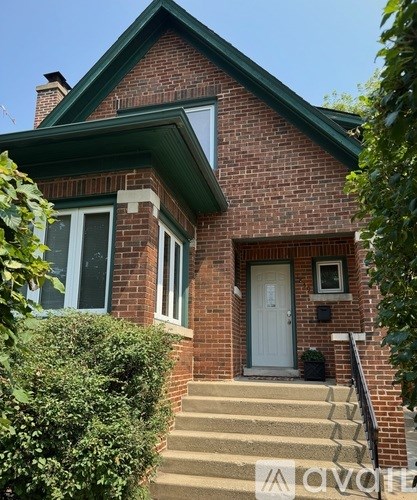 A brick house with a white door and a small window above the door.