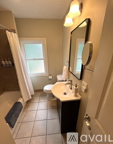 A bathroom with a sink, mirror, and toilet.
