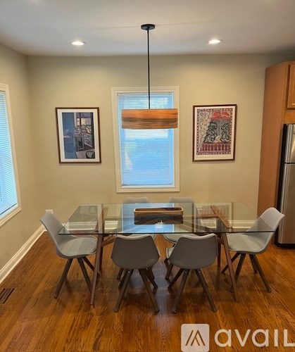 A dining room with a glass table and chairs.