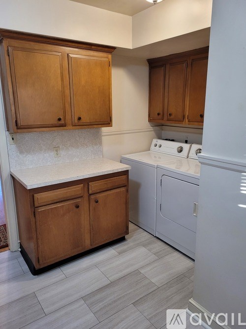 A kitchen with wooden cabinets and a white countertop.