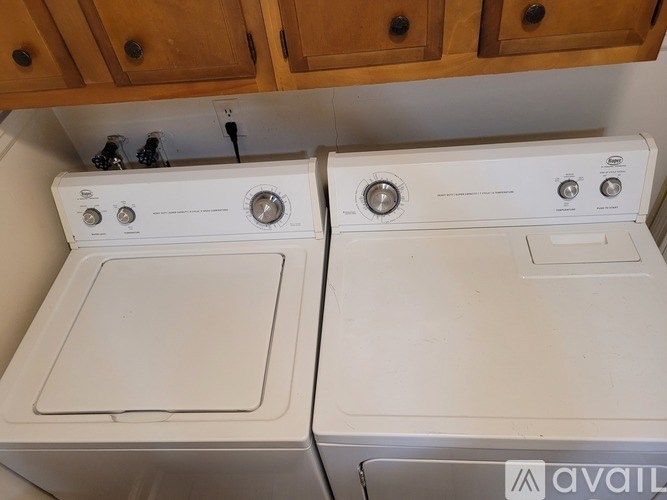 Two white washing machines are available for purchase.