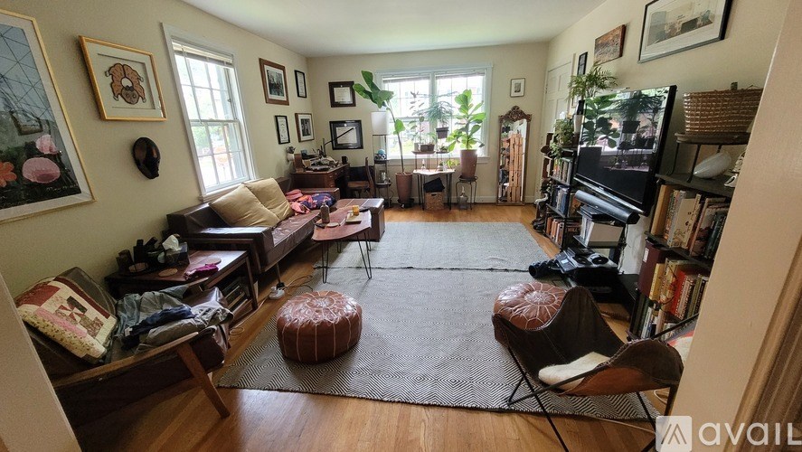 A living room with a couch, chair, and television.