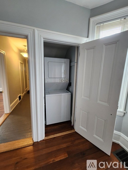 A white fridge and freezer are in a small room.