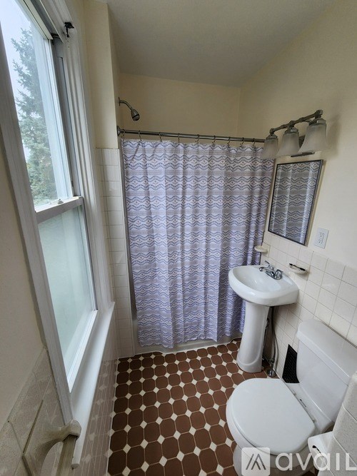 A bathroom with a brown and white checkered floor.