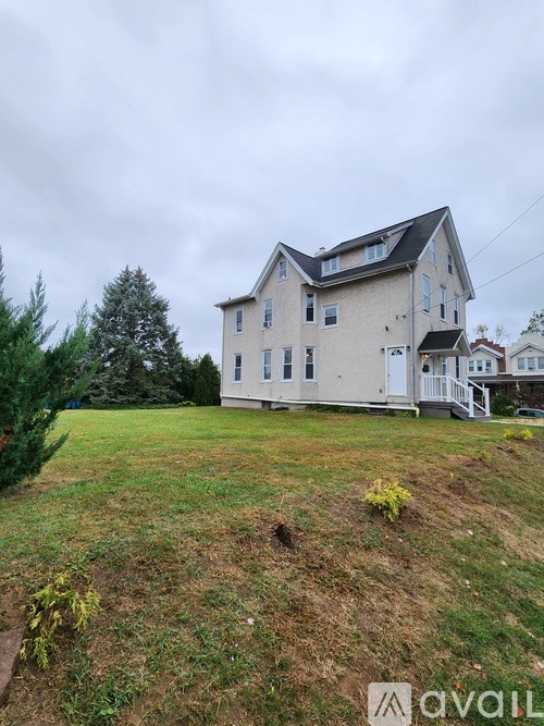 A house with a large front yard is for sale.