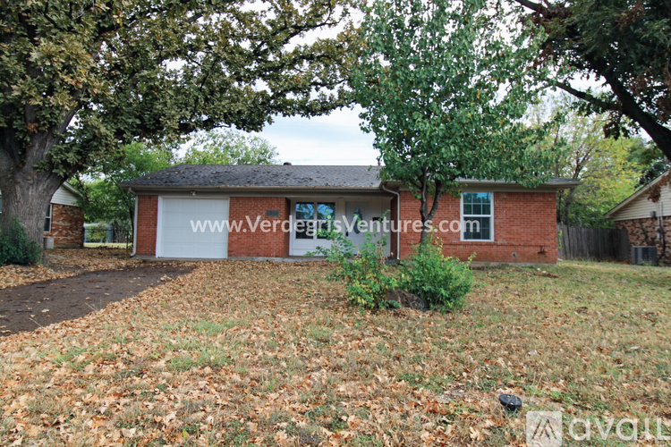 A house with a sign that says www.verdeventures.com.