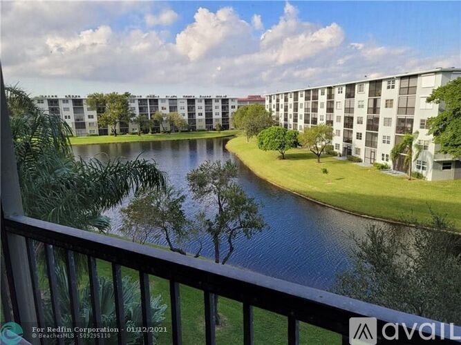 A balcony view of apartment buildings with a river in the foreground.