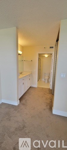 A carpeted hallway with a white door at the end.