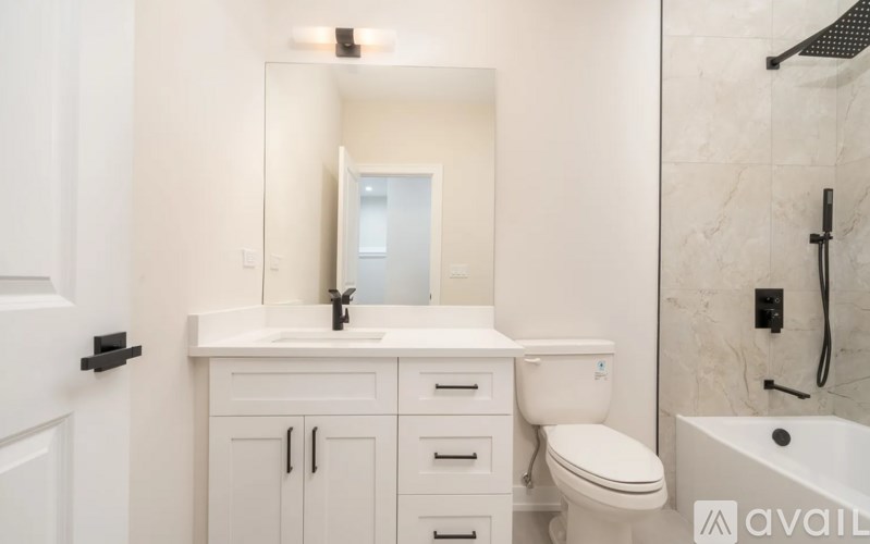 A white bathroom with a sink, toilet, and bathtub.