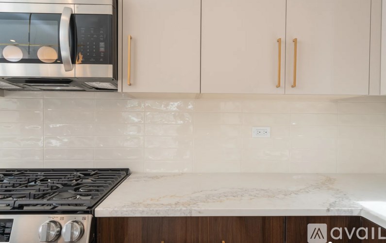 A kitchen with a stove top oven and a microwave above it.