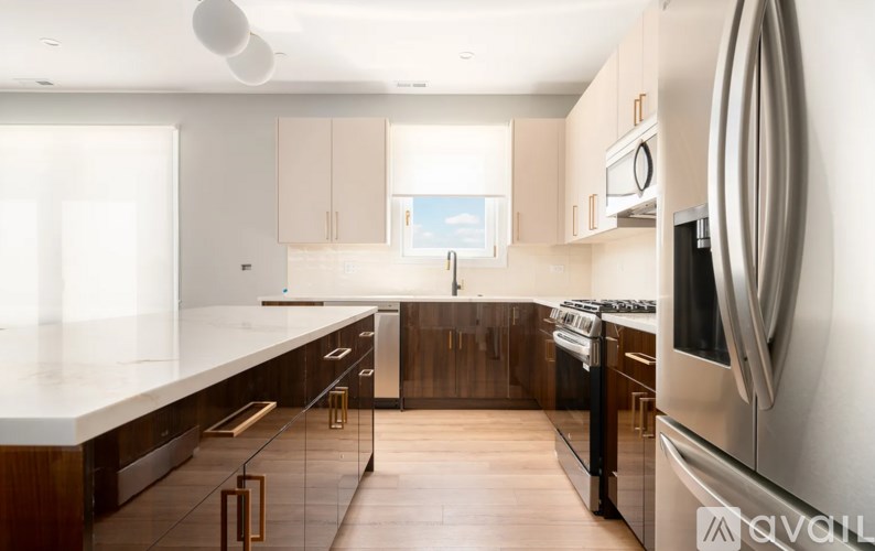 A modern kitchen with wooden cabinets and stainless steel appliances.