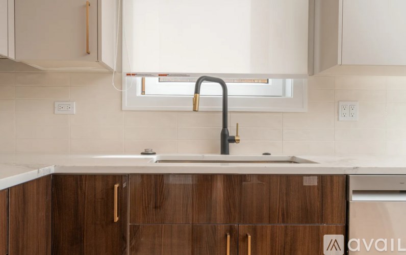 A kitchen with a sink and wooden cabinets.