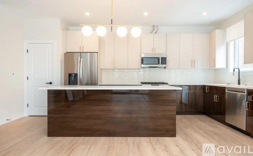 A modern kitchen with a wooden island in the middle.