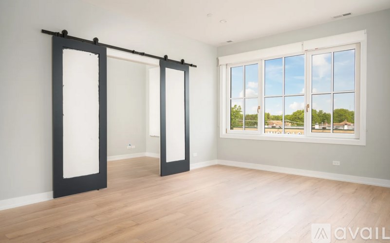 A room with a sliding door and a view of the outside.