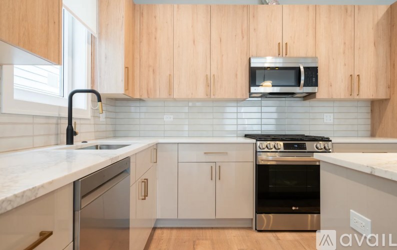 A kitchen with wooden cabinets and a stainless steel oven.