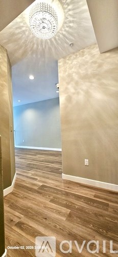 A room with wooden flooring and a ceiling fan.