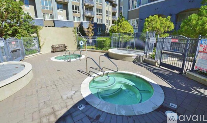 A round hot tub sits in the middle of a patio area.