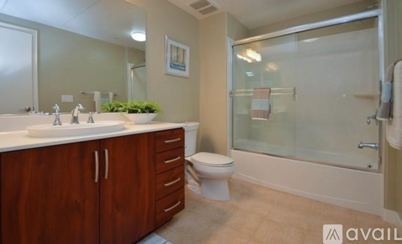 A bathroom with a toilet, sink, and shower.