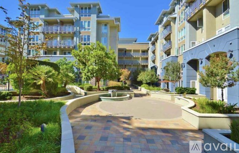 A modern apartment complex with a landscaped courtyard and pathways.