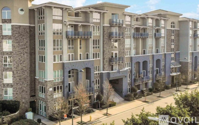 Apartment complex with balconies and multiple stories.