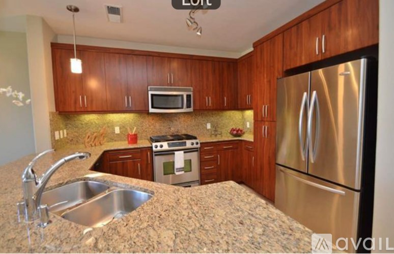 A kitchen with a sink, stove, and refrigerator.