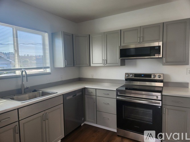 A kitchen with a stove, oven, and cabinets.
