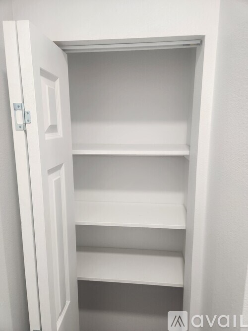 A white open closet with shelves.