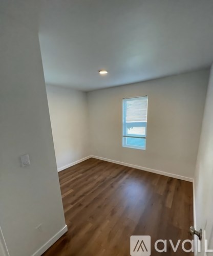 A room with wooden floors and a window.