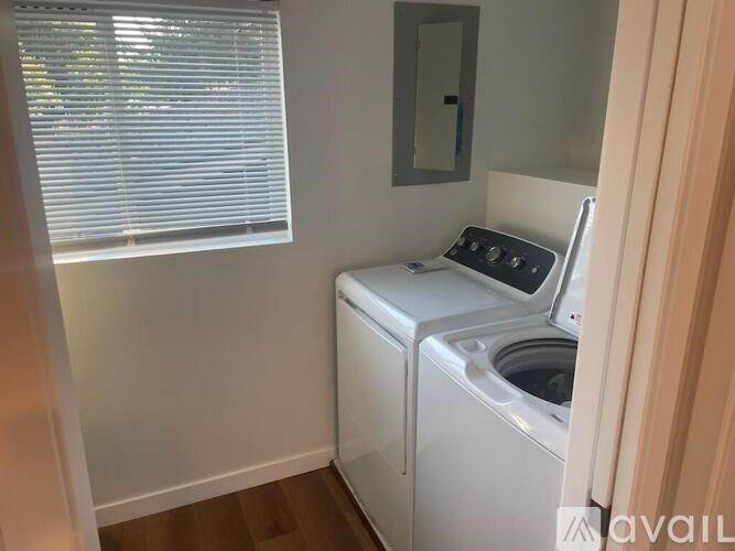 A small laundry room with a washer and dryer.
