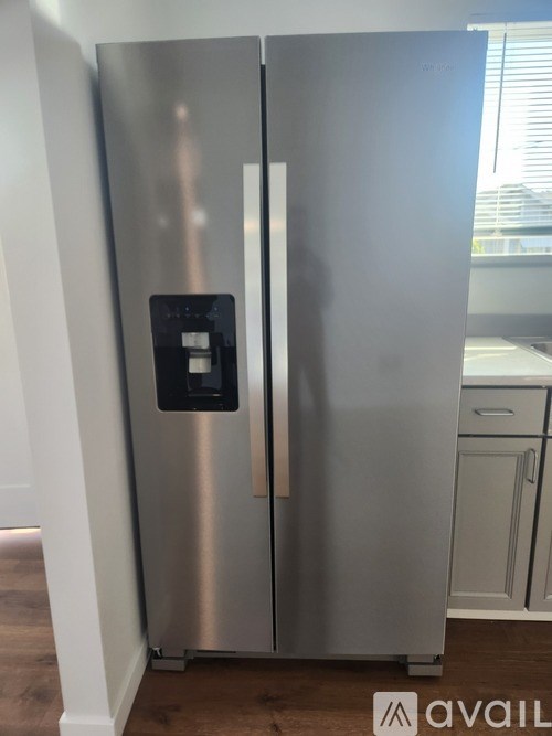 A stainless steel refrigerator with a digital display on the door.