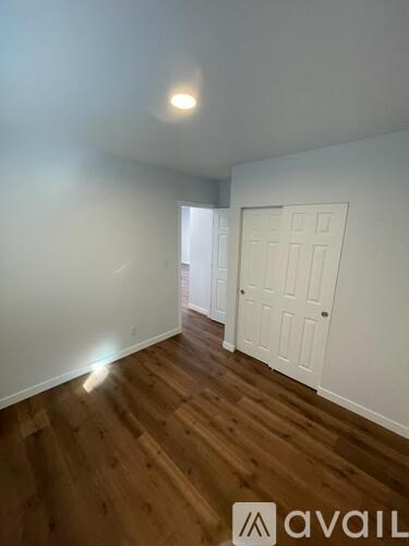 A room with wooden floors and white walls.