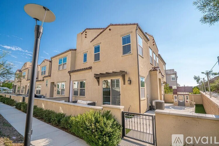 A row of houses with a sign that says "available" in front of them.