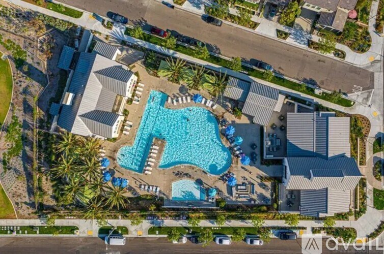 An aerial view of a resort with a large swimming pool.
