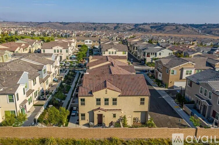 A residential area with houses and a clear sky.