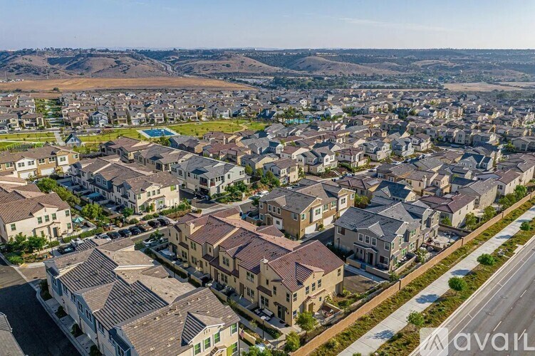 A bird's eye view of a residential area with houses and roads.