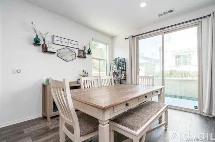 A dining room with a wooden table and chairs.